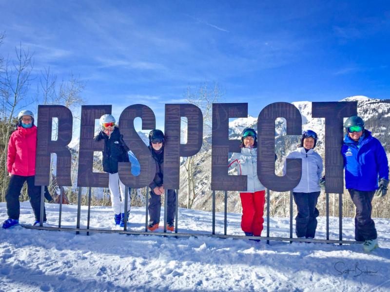 Skiers inbetween letters of RESPECT on Aspen Mountain in 2018
